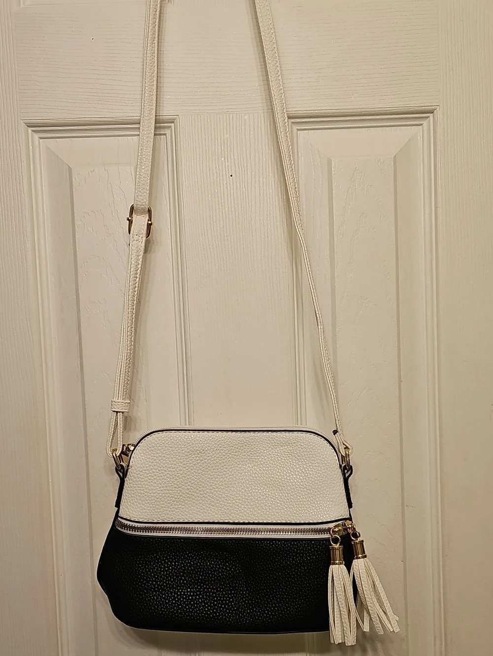 Two-Tone White and Black Crossbody Bag with Tassel Accent